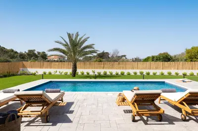 a swimming pool with two lounge chairs and a swimming pool at Ixian Memory in Triánta