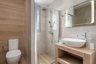 a bathroom with a toilet and a sink and a shower at Ixian Memory in Triánta