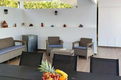 a room with chairs and a table with a bowl of fruit at Sea View Villa Ellada, Just 3km From Lindos in Líndos