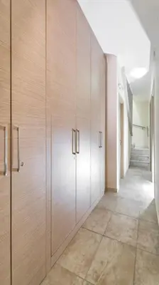 a hallway with wooden cabinets in a room at Sea View Villa Ellada, Just 3km From Lindos in Líndos
