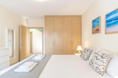 a bedroom with a large white bed with two pillows at Sea View Villa Ellada, Just 3km From Lindos in Líndos