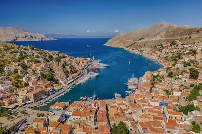an aerial view of a harbor with boats in the water at Annikas Port View-Ground in Symi