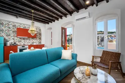 a living room with a blue couch and a table at Annikas Port View-Ground in Symi