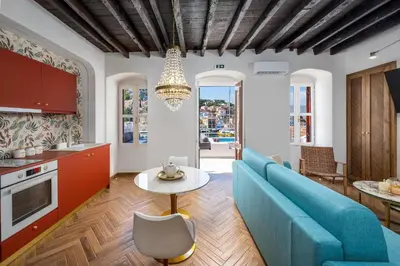 a living room with a blue couch and a table at Annikas Port View-Ground in Symi