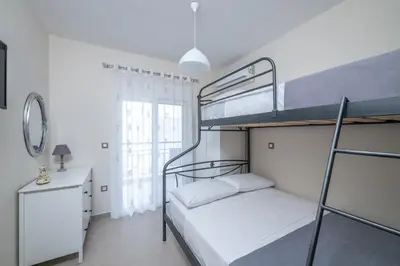 a bedroom with two bunk beds and a desk at Nimarevi Apartment in Soroni