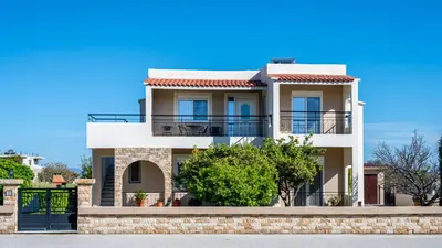 a house with a blue sky in the background at Nimarevi Apartment in Soroni