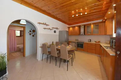a kitchen with a table and chairs in a kitchen at Captain Ilias House Chalki in Halki