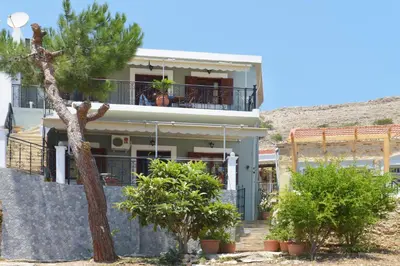 a house with a tree in front of it at Captain Ilias House Chalki in Halki