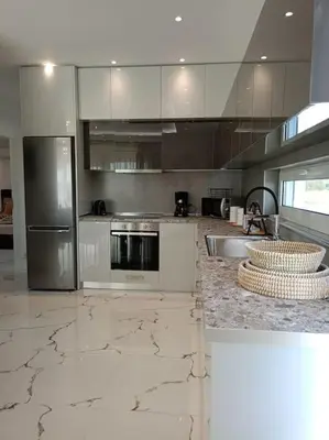 a kitchen with marble counter tops and stainless steel appliances at Blue Sky Villa in Kalithies