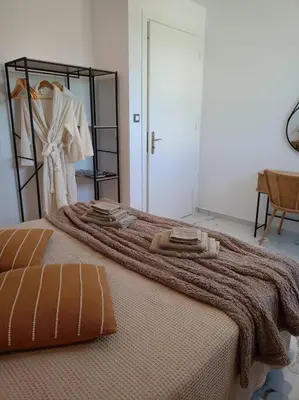 a bedroom with a bed with a blanket on it at Blue Sky Villa in Kalithies