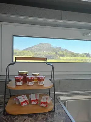 a shelf with four jars of food in a kitchen at Blue Sky Villa in Kalithies