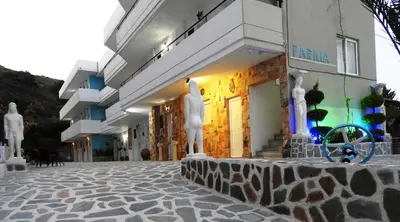 a building with statues in front of it at Farkia Exclusive Studios in Faliraki