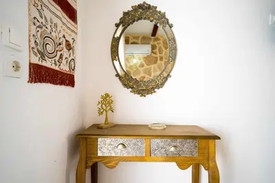 a dressing table with a mirror on a wall at Farkia Exclusive Studios in Faliraki