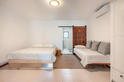 a bedroom with two beds and a couch at Ily’s House in Pastida