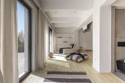 a living room with a large window and a couch at RLM Prime Beach Panoramic Villa in Kolimbia