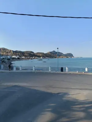 a view of a beach with a body of water at Spot on the sea in Archangelos