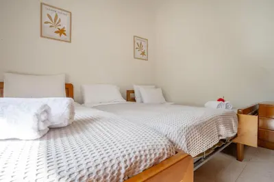 two beds sitting next to each other in a bedroom at Mike's House in Kremasti near the Beach Rhodes in Kremasti