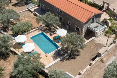 an aerial view of a building with a swimming pool at Villa Roi in Kalathos
