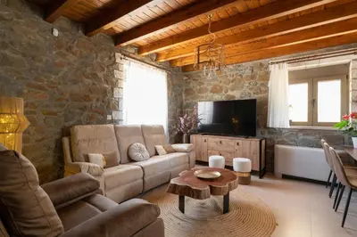 a living room with a couch and a tv at Villa Roi in Kalathos