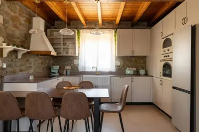 a kitchen with a table and chairs in a room at Villa Roi in Kalathos