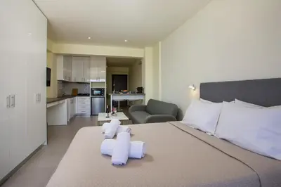 a bedroom with a bed with two teddy bears on it at Eden's Azalea Luxury Suite in Rhodes Town
