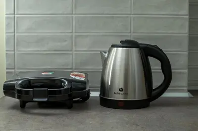 a tea kettle and a toaster sitting on a counter at Eden's Azalea Luxury Suite in Rhodes Town