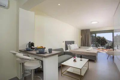 a living room with a couch and a bed at Eden's Azalea Luxury Suite in Rhodes Town