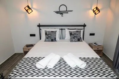 a bedroom with a bed with two white pillows at Calliope's Rhodes City Comfort in Rhodes Town