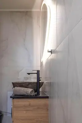a bathroom with a sink and a mirror at Calliope's Rhodes City Comfort in Rhodes Town