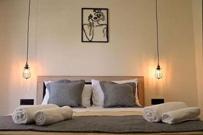 a bedroom with a bed with towels on it at Calliope's Rhodes City Comfort in Rhodes Town