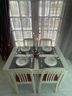a white table with plates and wine glasses on it at Summer Diamond in Kremasti
