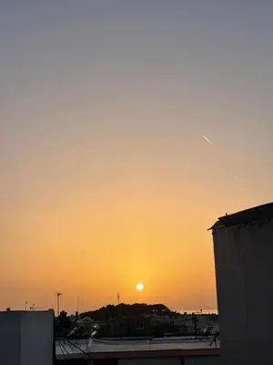 a sunset over a parking lot with the sun in the sky at Summer Diamond in Kremasti
