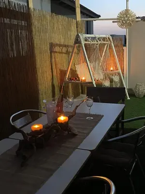 a table with a lamp and candles on it at Summer Diamond in Kremasti