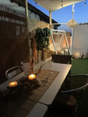 a table with two candles and a bottle of wine on it at Summer Diamond in Kremasti
