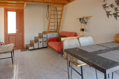 a living room with a couch and a ladder at Aeneo Studio 2 in Symi