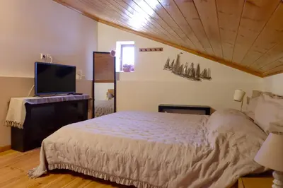 a bedroom with a bed and a flat screen tv at Aeneo Studio 2 in Symi