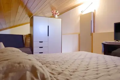 a bedroom with a white dresser and a bed at Aeneo Studio 2 in Symi