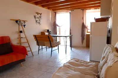 a living room with a table and a couch at Aeneo Studio 2 in Symi