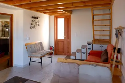 a living room with a loft bed and a ladder at Aeneo Studio 2 in Symi
