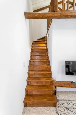 a wooden staircase in a house with a wooden railing at Villa del Capo Suites in Rhodes Town