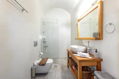 a bathroom with a sink and a toilet and a mirror at Villa del Capo Suites in Rhodes Town