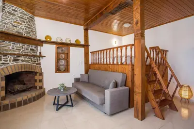 a living room with a couch and a fireplace at Rhodes VistaPeak Retreat in Áyios Isídhoros