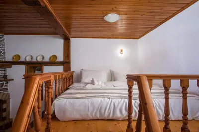 a bed in a room with a wooden ceiling at Rhodes VistaPeak Retreat in Áyios Isídhoros