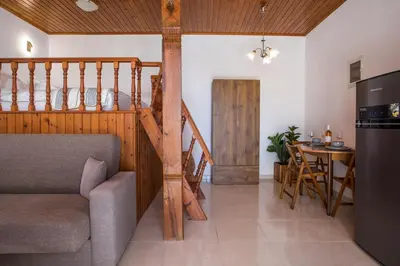 a living room with a couch and a table at Rhodes VistaPeak Retreat in Áyios Isídhoros