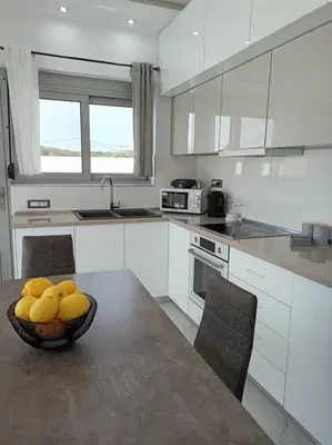 a kitchen with a bowl of fruit on a table at Traounou Bay villa in Afantou