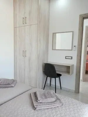 a bedroom with a desk and a bed and a chair at Traounou Bay villa in Afantou