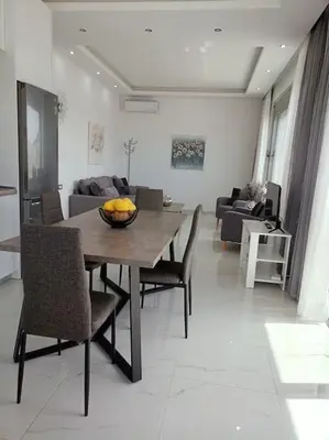 a dining table and chairs in a living room at Traounou Bay villa in Afantou