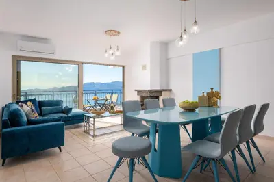 a living room with a blue table and chairs at Artoria Apartment 1 Groundfloor in Haraki