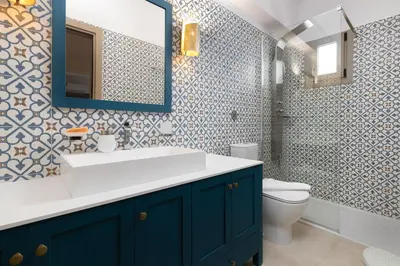 a bathroom with a sink and a toilet and a mirror at Artoria Apartment 1 Groundfloor in Haraki