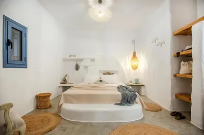 a bedroom with a bed in a white room at Ninémia Sea living in Archangelos